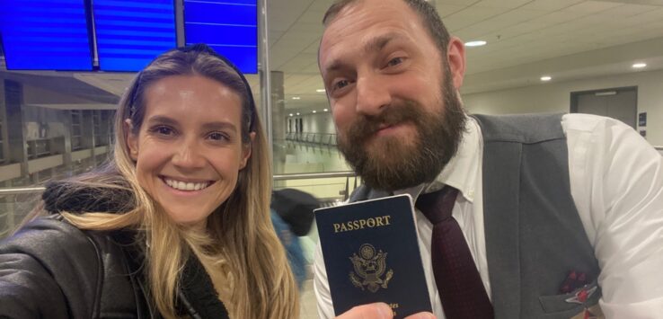 a man and woman holding a passport