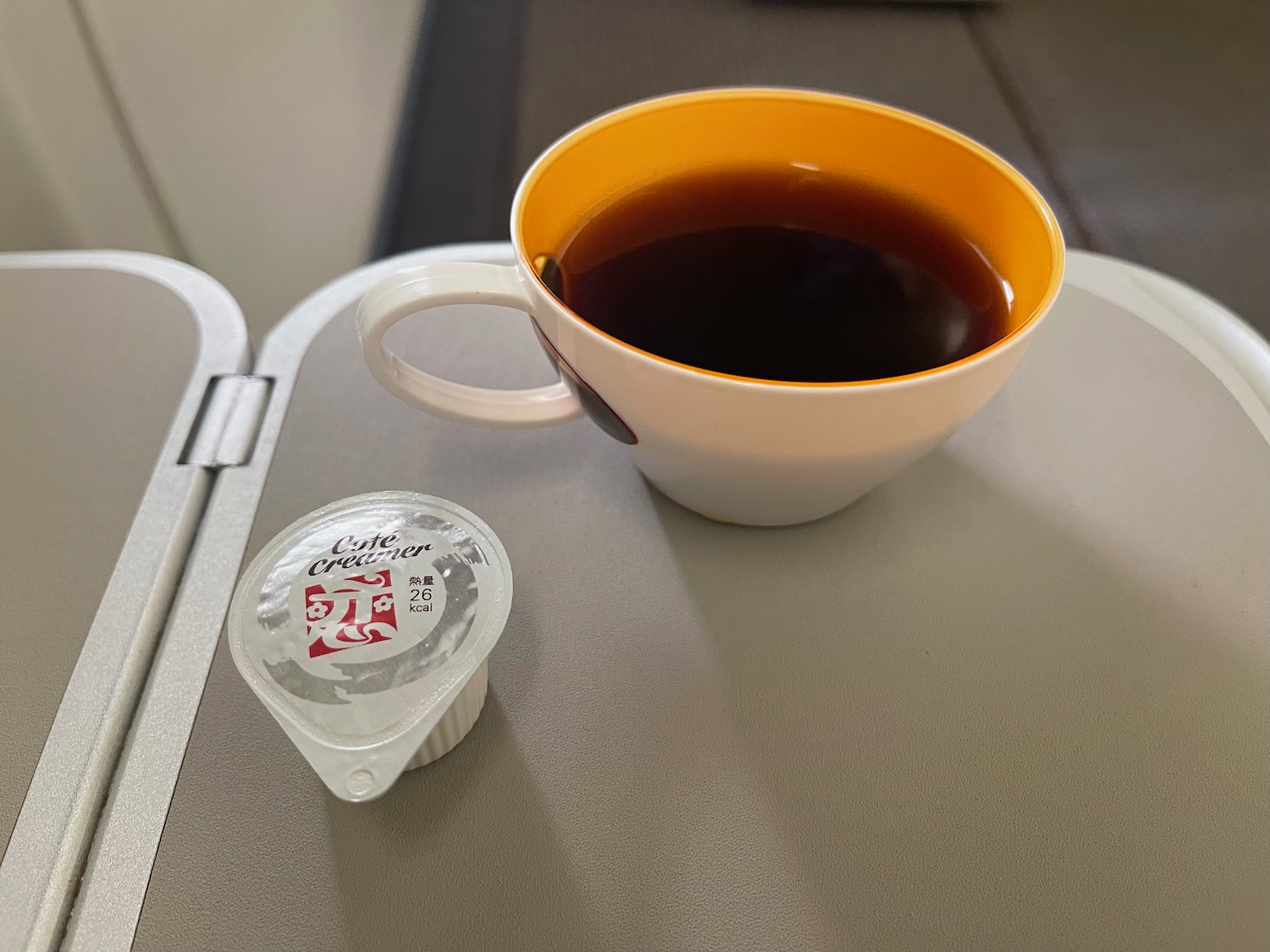 a cup of coffee and yogurt on a table