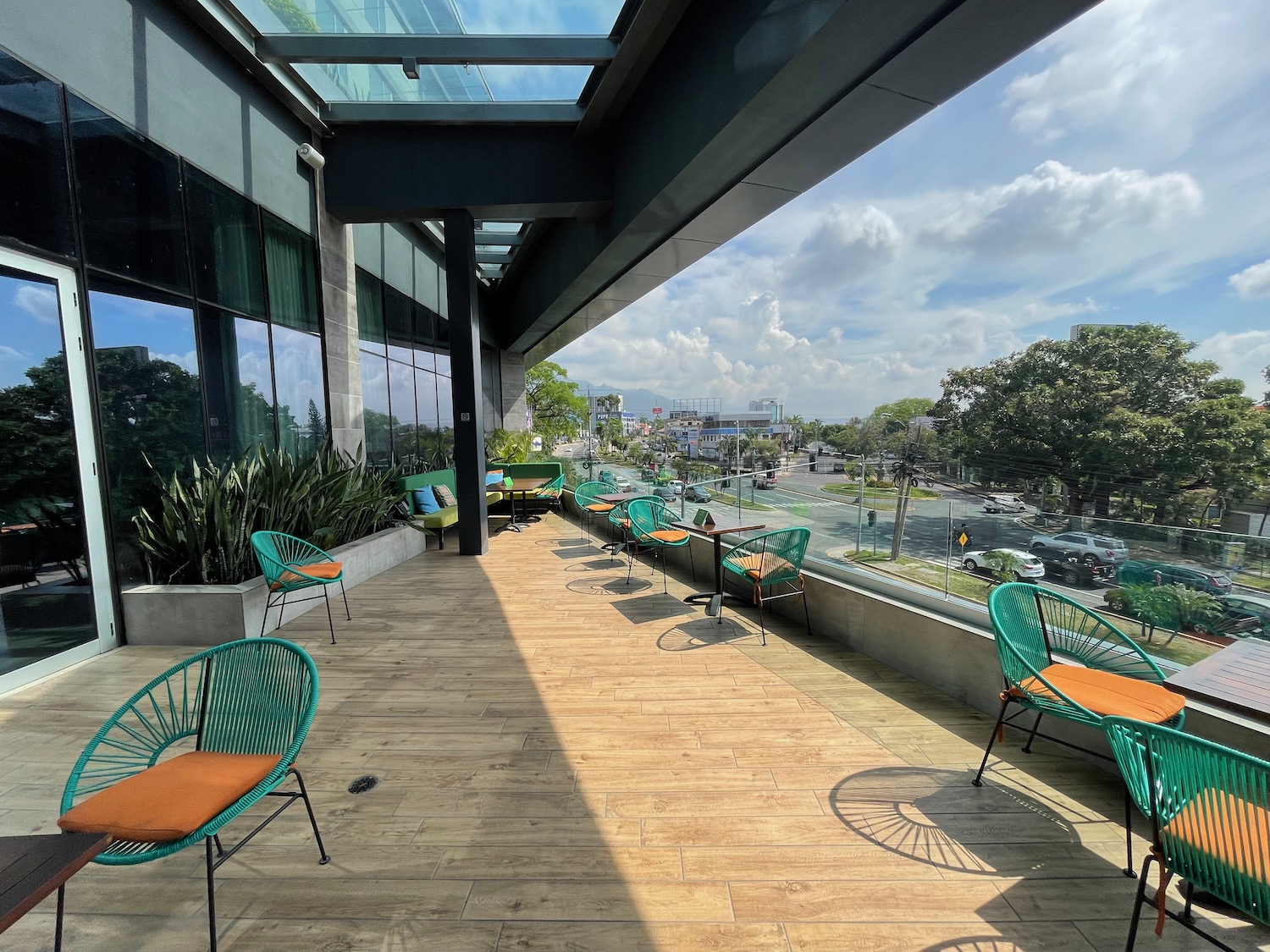 a patio with chairs and tables on a sunny day