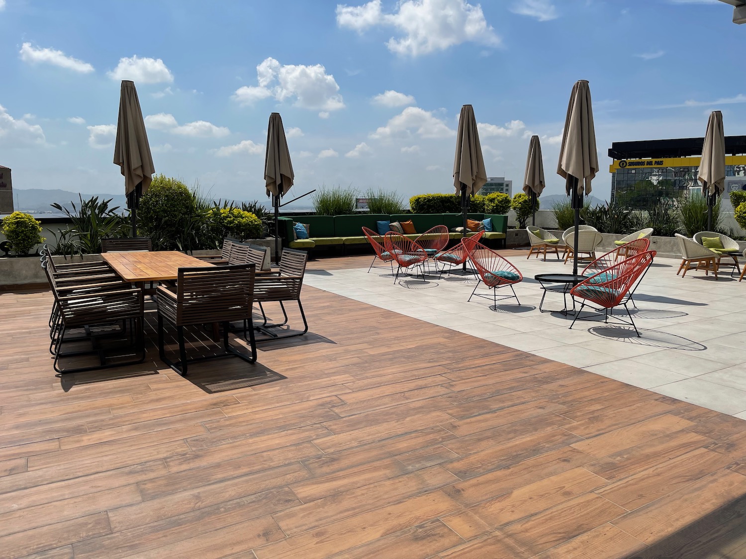 a patio with chairs and umbrellas