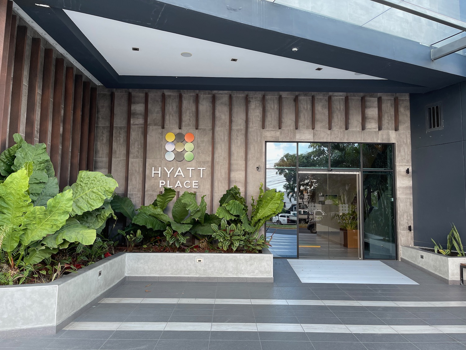 a building with plants and a sign