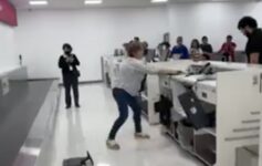 a woman in a white shirt and blue jeans standing in front of a white counter