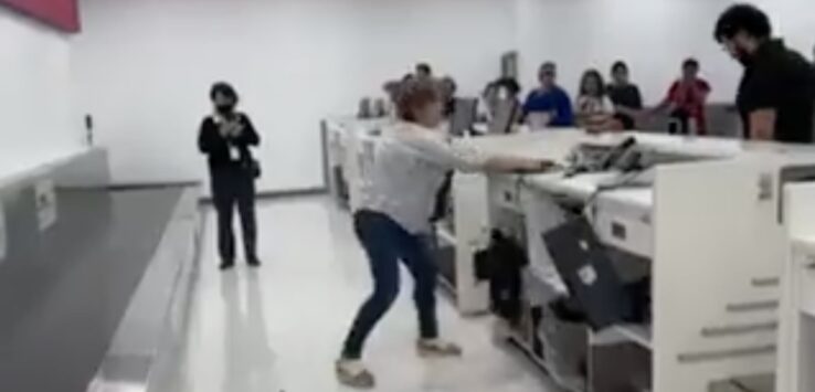 a woman in a white shirt and blue jeans standing in front of a white counter