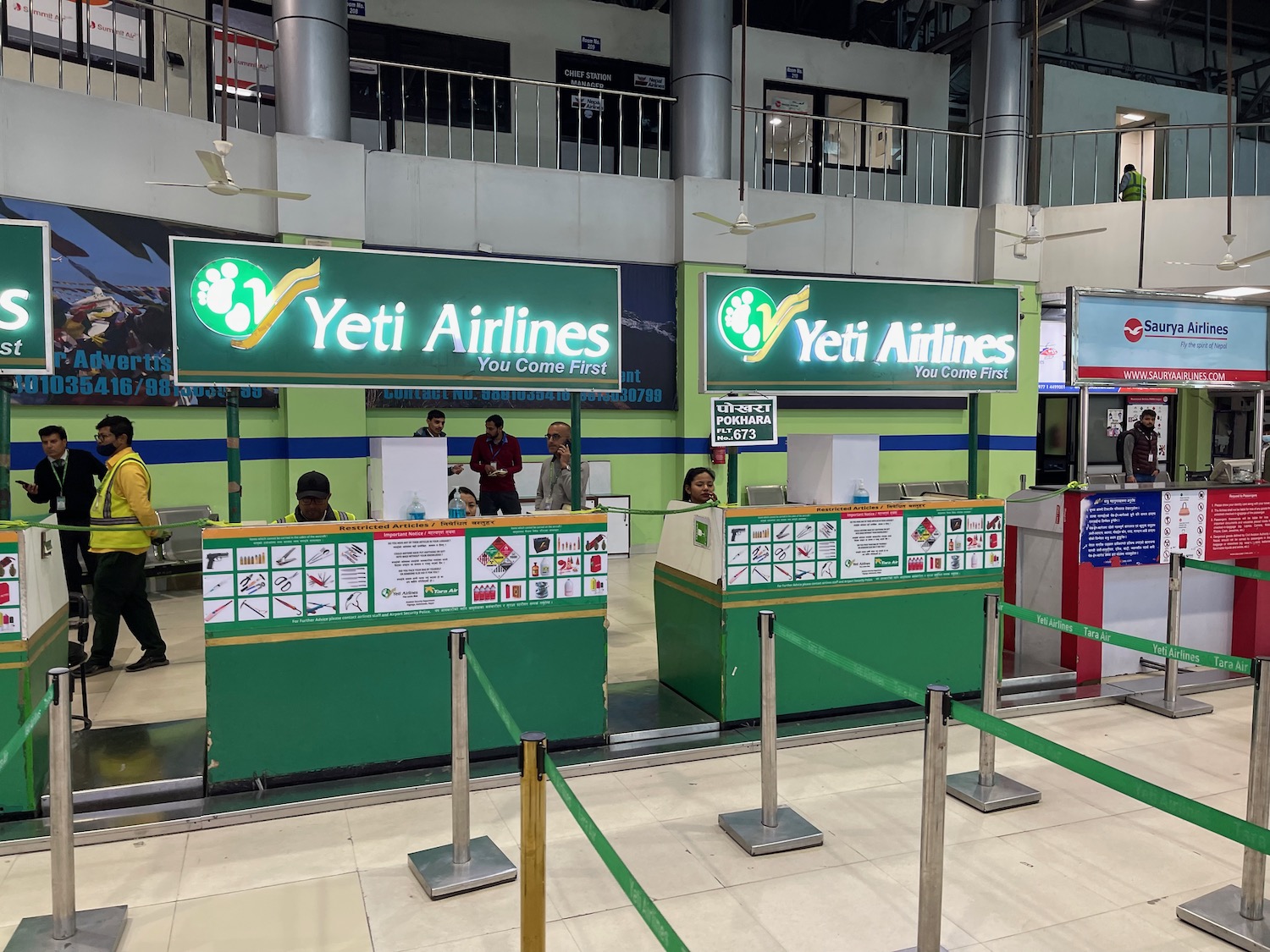 people standing in a line at a check in counter