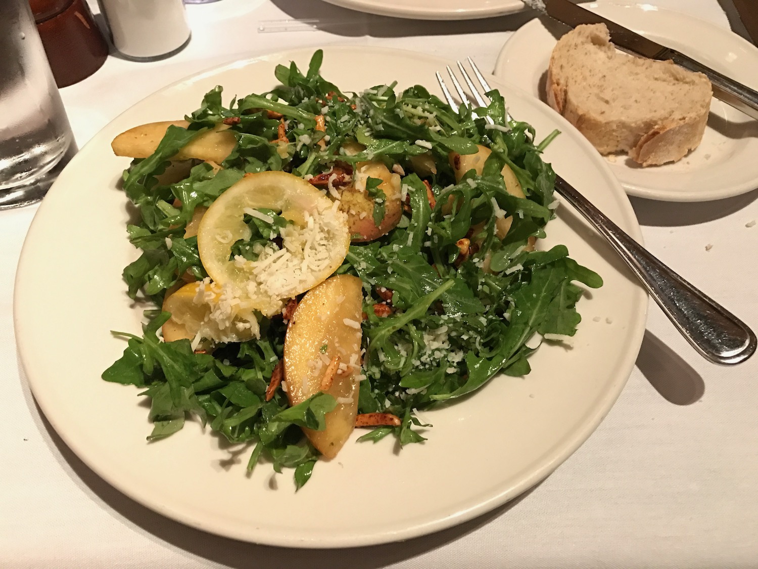 a plate of salad with potatoes and lemons