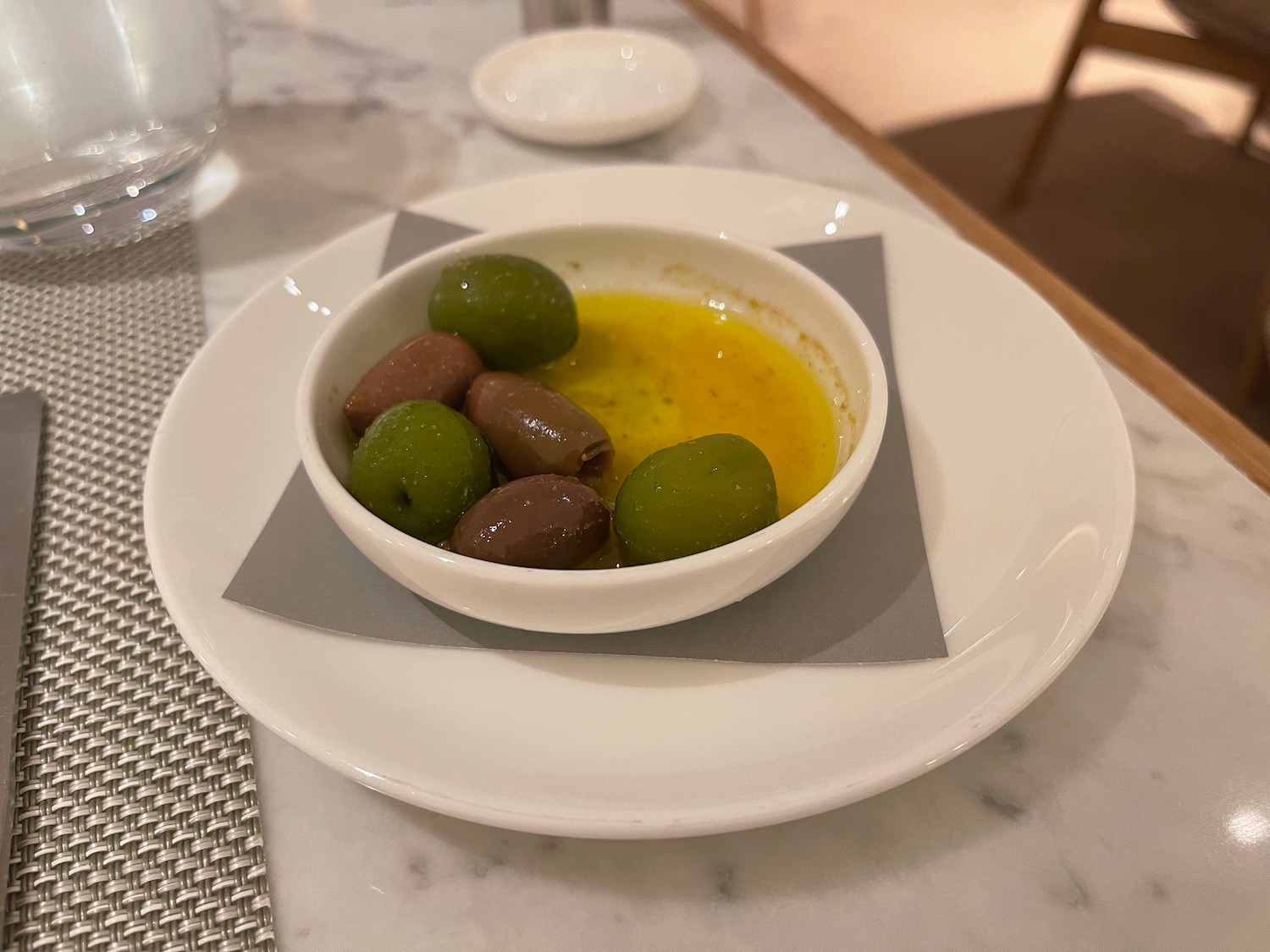 a bowl of olives on a plate