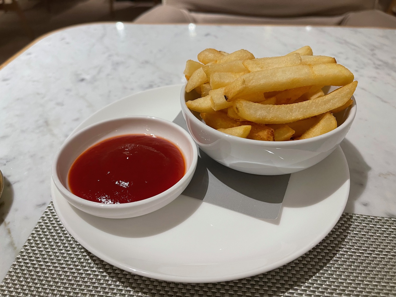 a bowl of french fries and ketchup on a plate