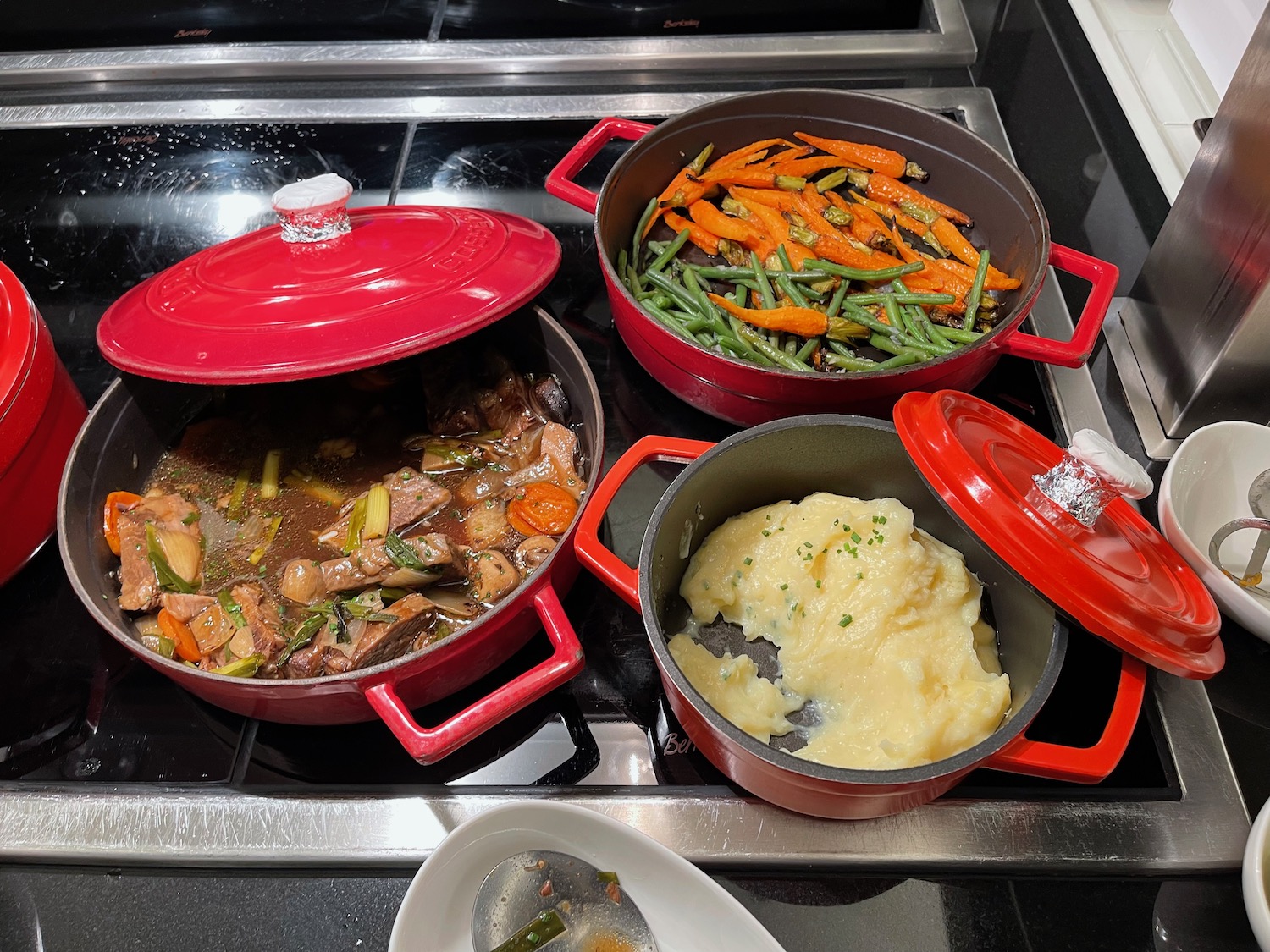 a group of pots with food on a stove