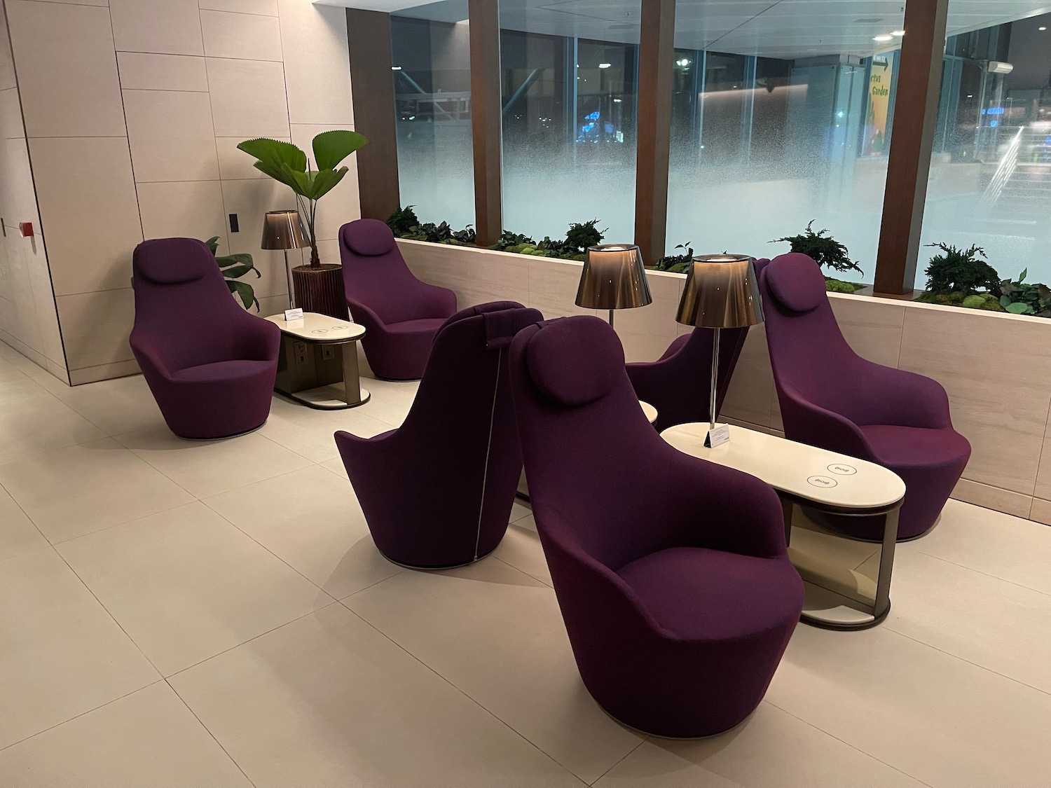 a room with purple chairs and tables