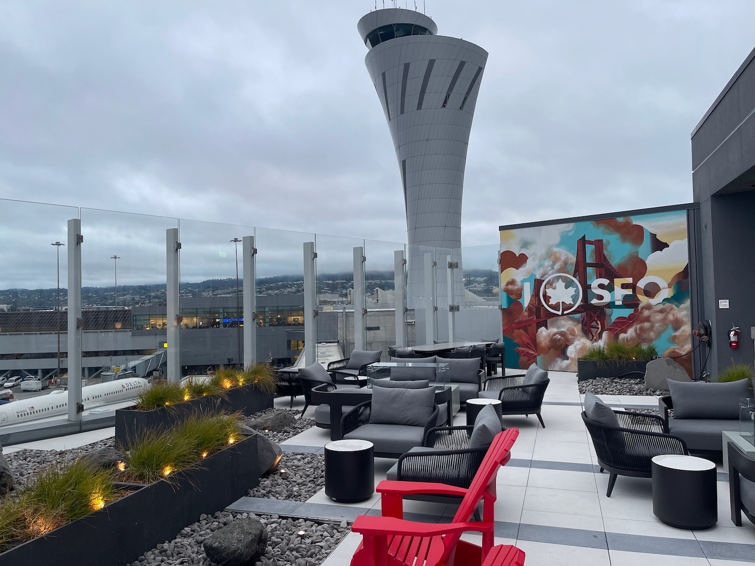 a rooftop with chairs and a tower