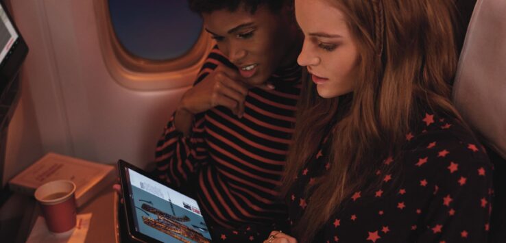 a couple of women looking at a tablet