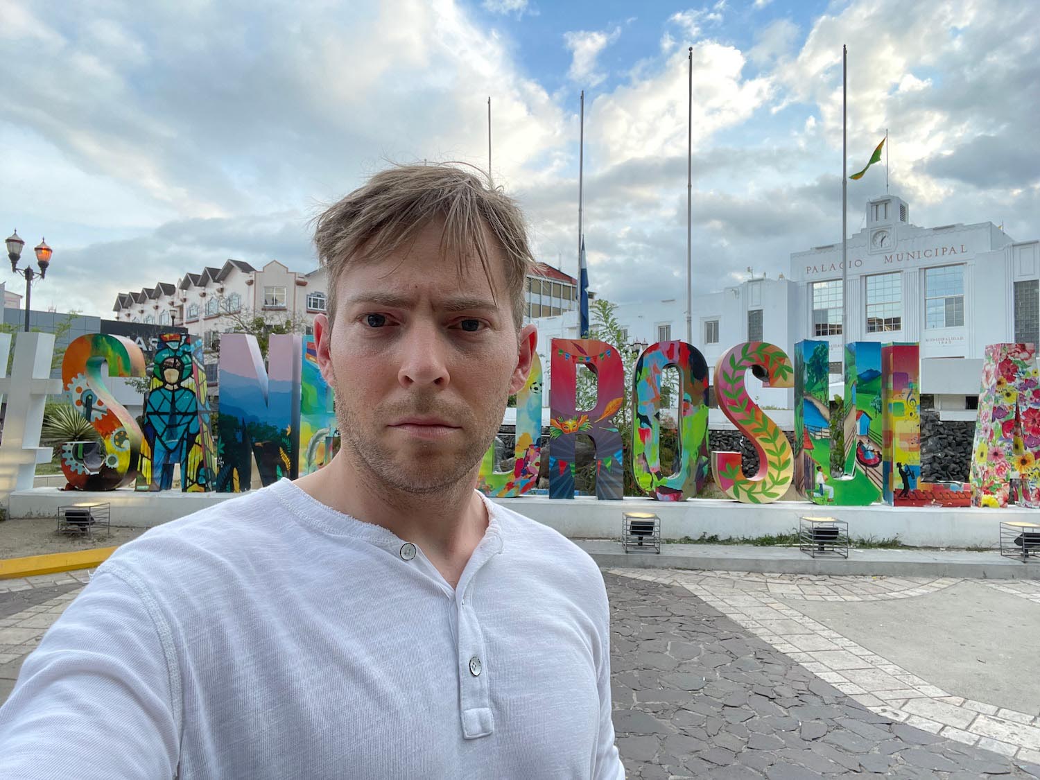 a man taking a selfie in front of a sign