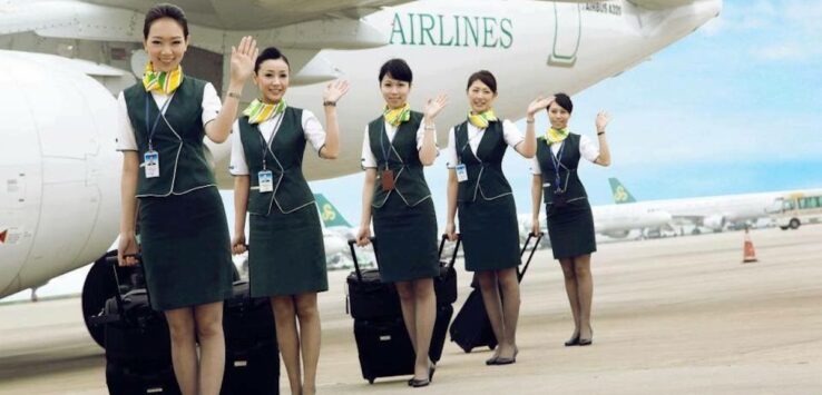 a group of women in uniform waving