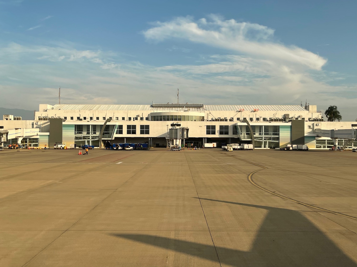 a large white building with a lot of planes in the background