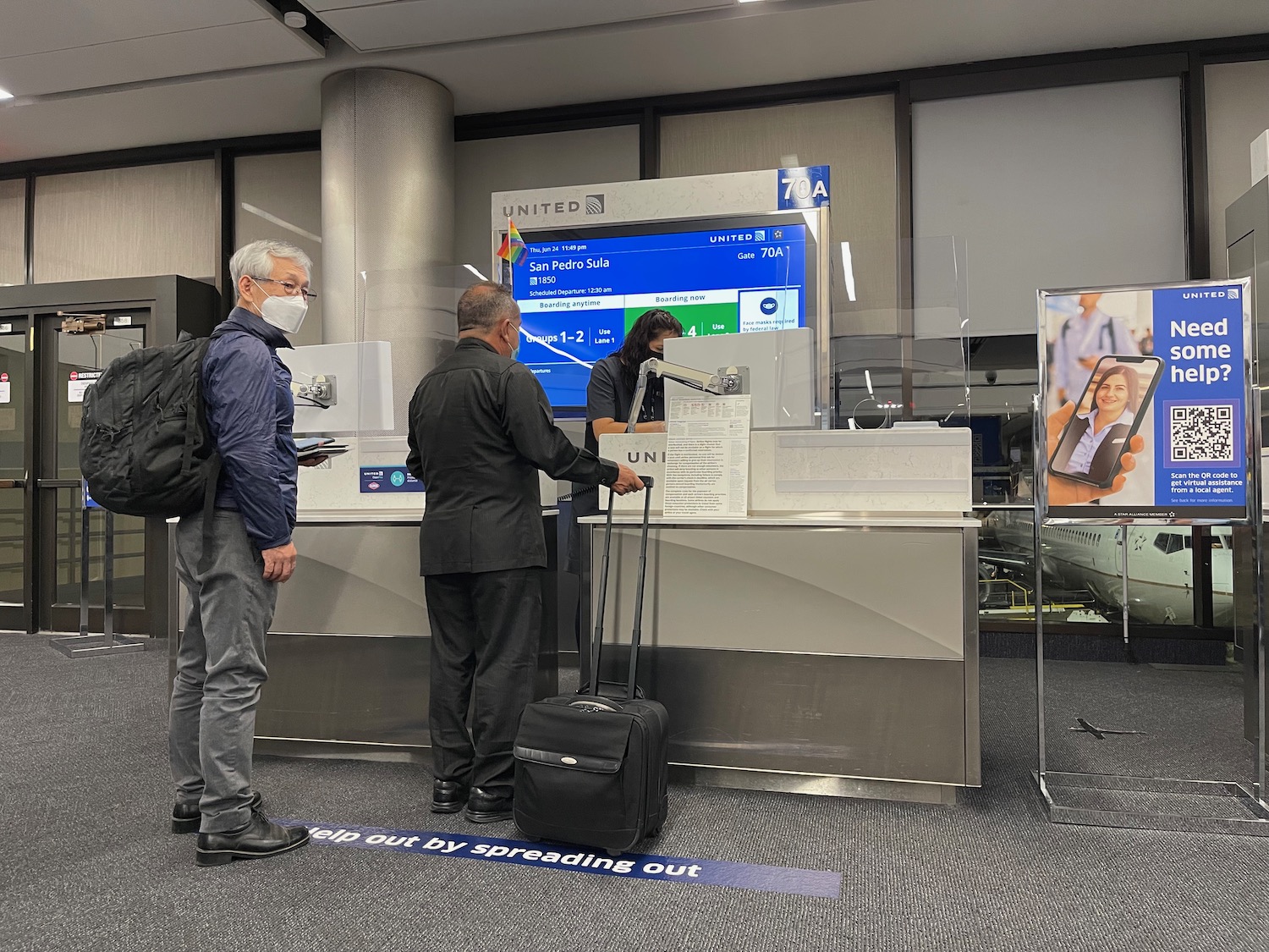 a group of people standing in front of a screen