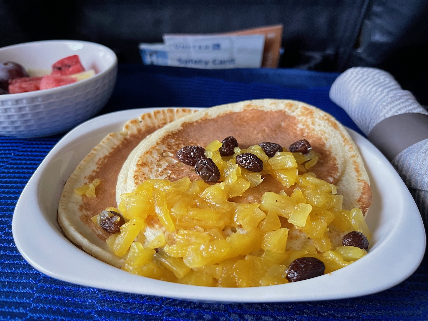 a plate of pancakes with fruit topping