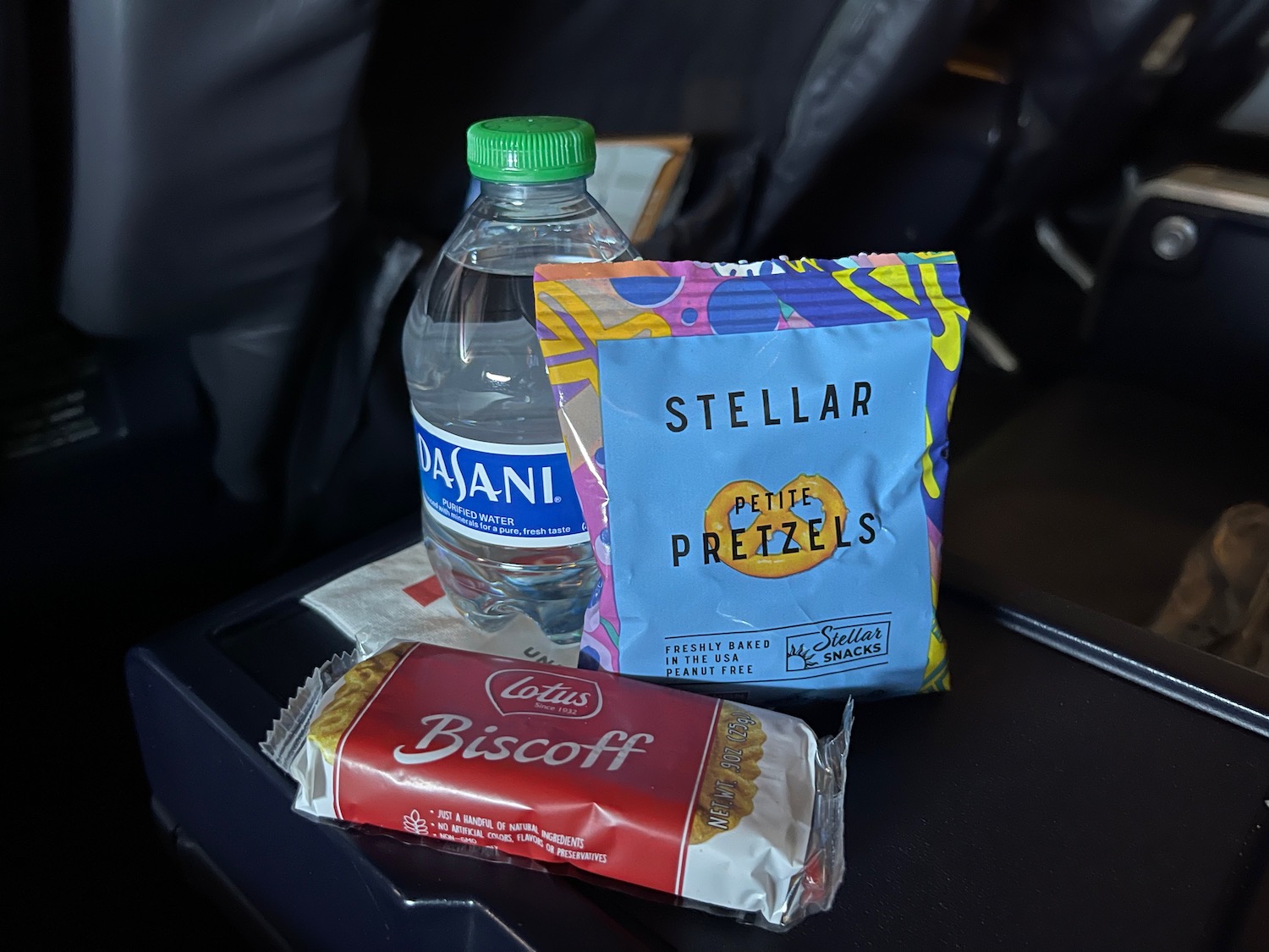 a bottle of water and snacks on a chair