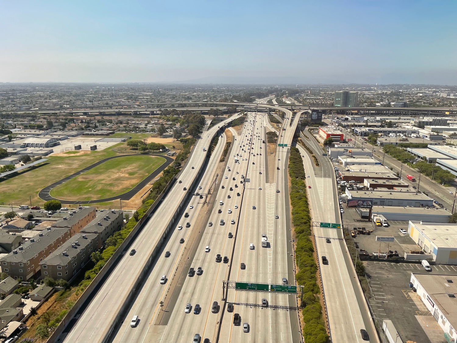 a highway with many cars and buildings