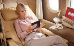 a woman sitting in a chair using a tablet