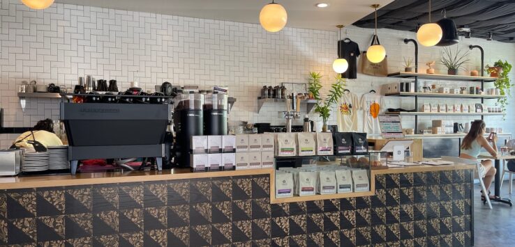a coffee shop with a counter and shelves