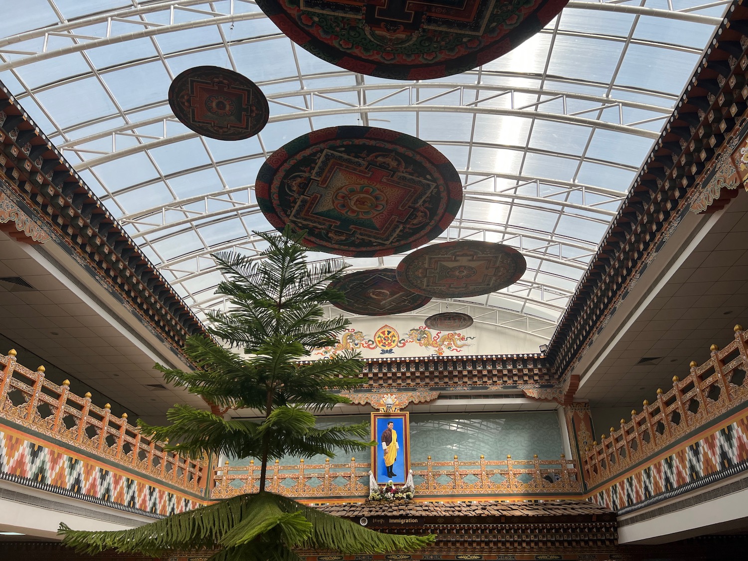 a tree in a room with a glass roof