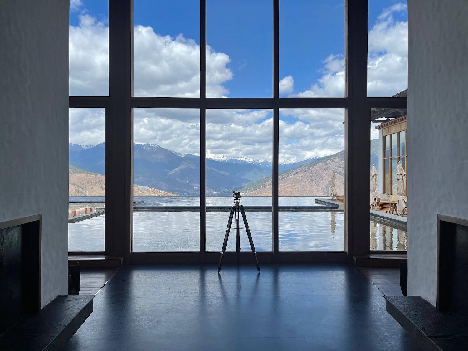 a tripod in front of a large window