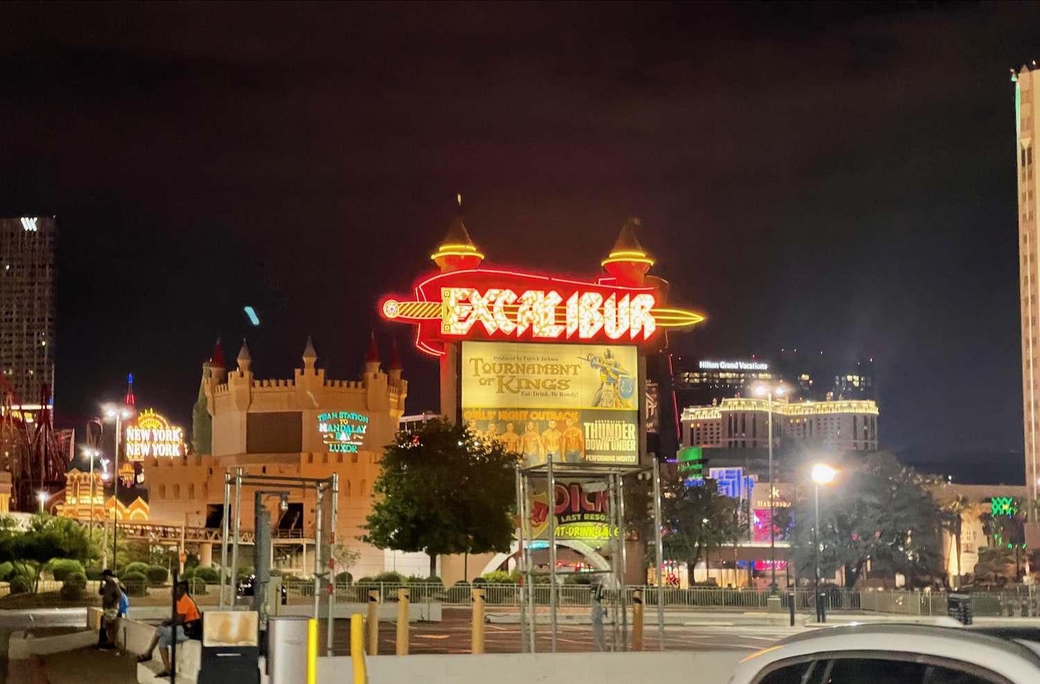 a large sign with a lit up sign in front of a large building