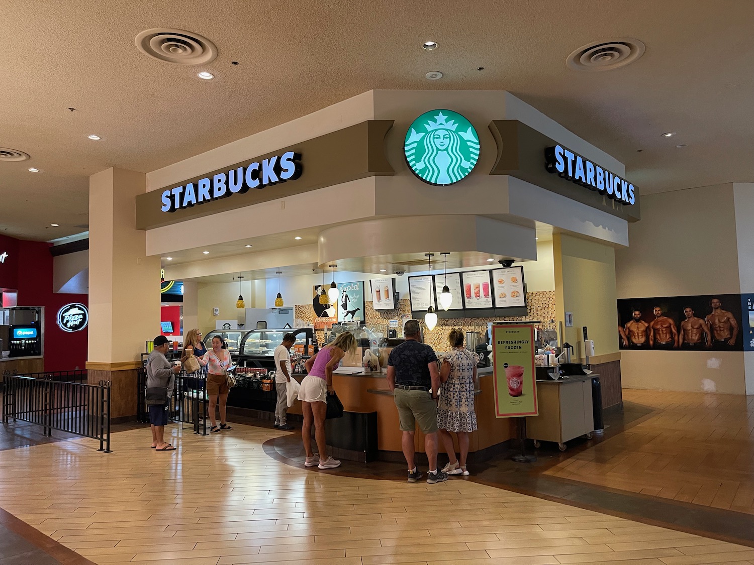 people standing in front of a starbucks coffee shop