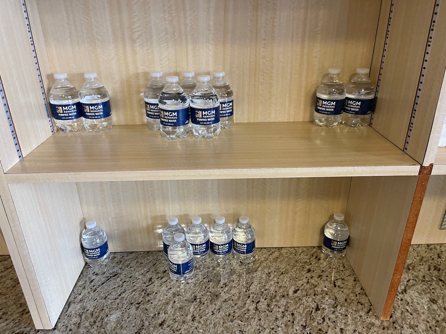 a shelf with water bottles on it