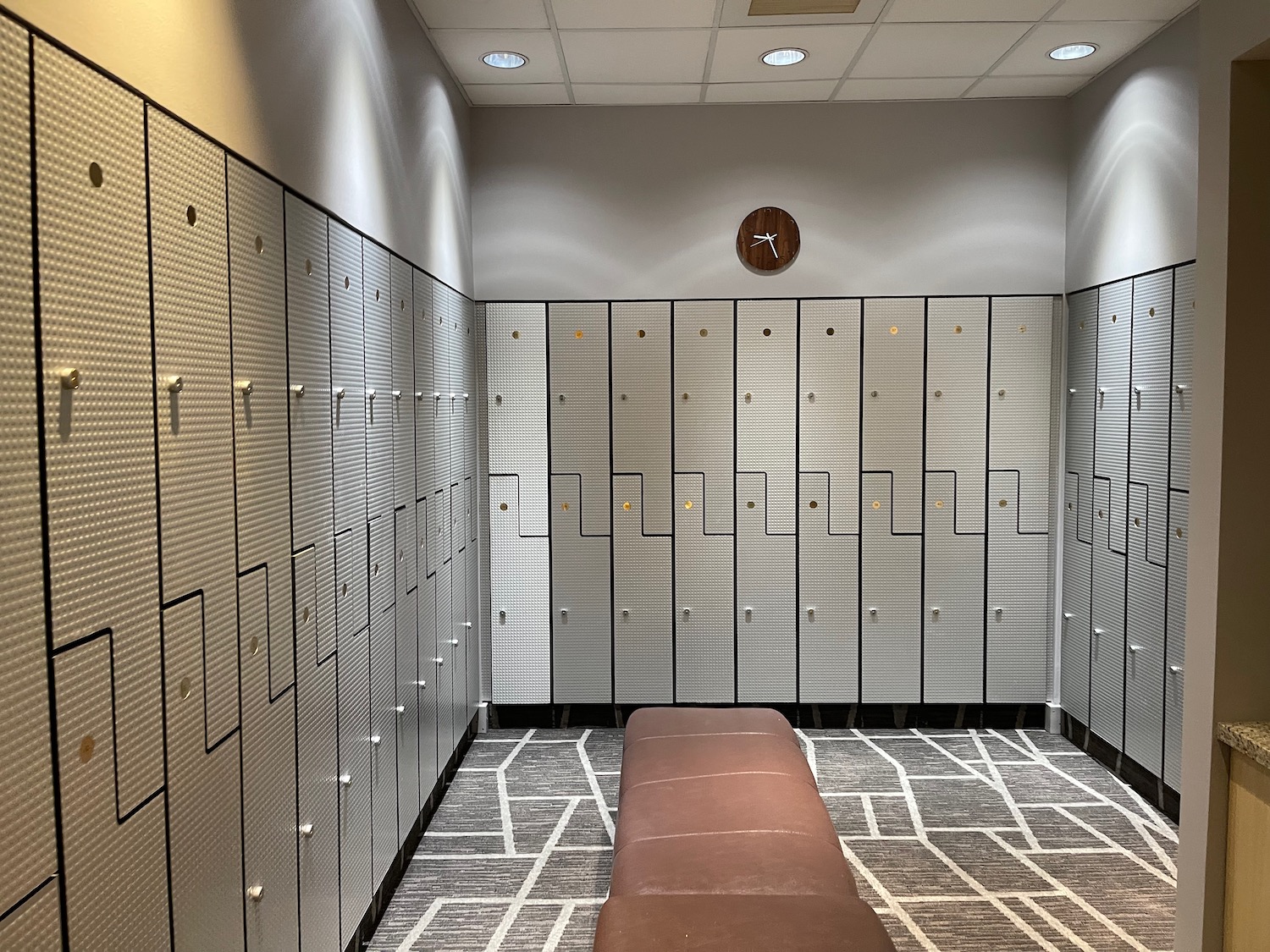 a locker room with a bench and many lockers