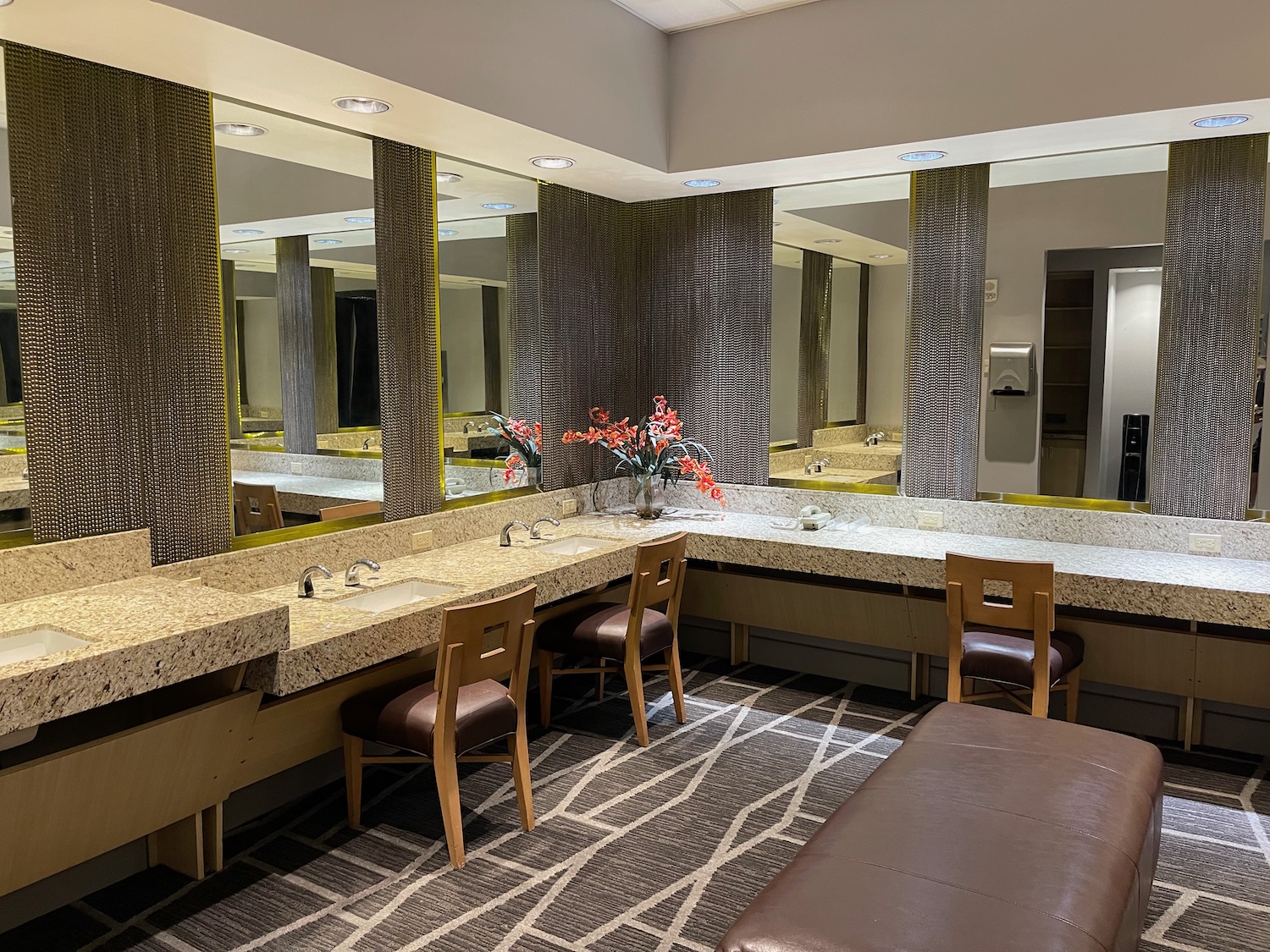 a bathroom with a large mirror and sinks