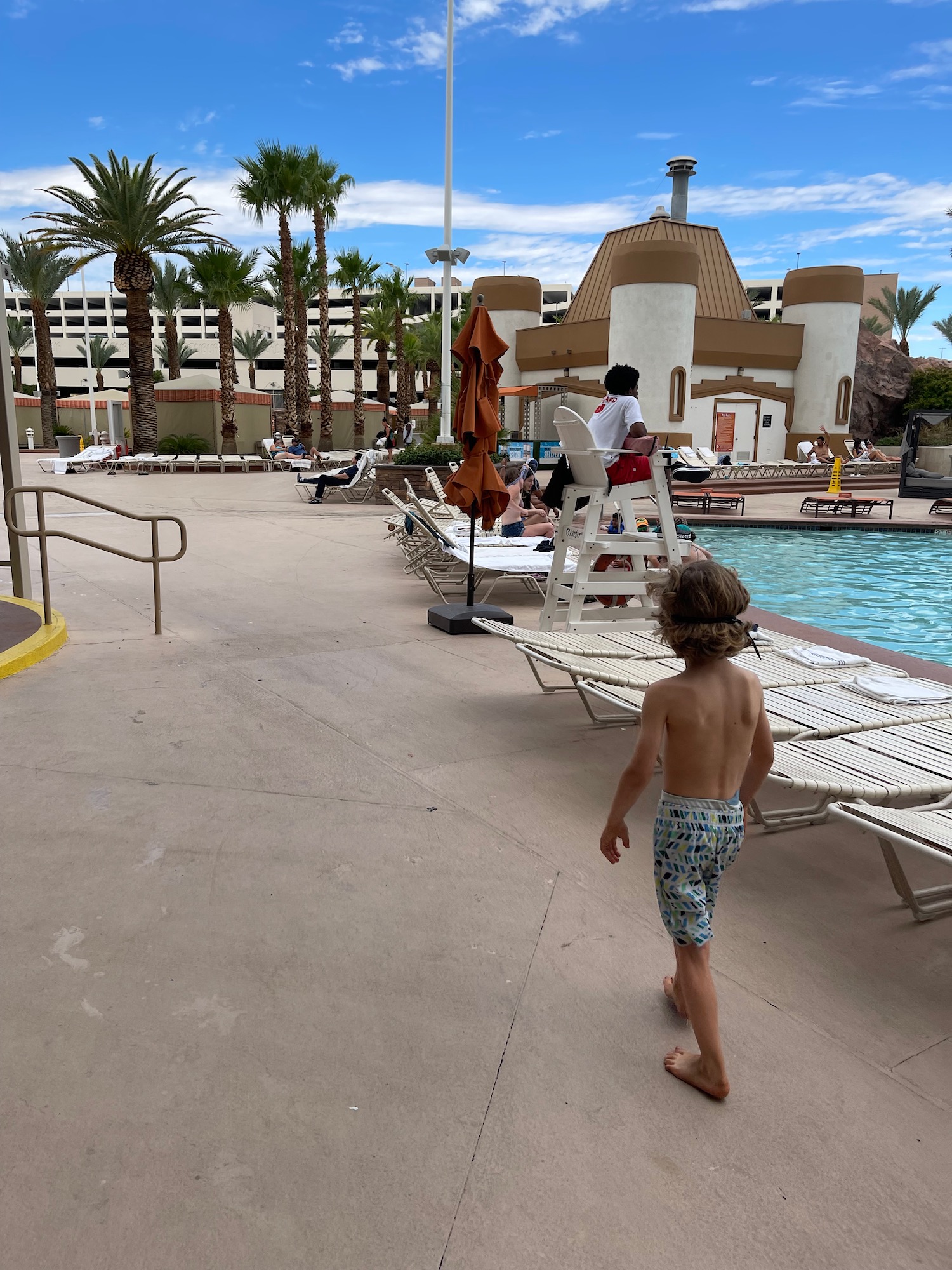 a boy walking by a pool