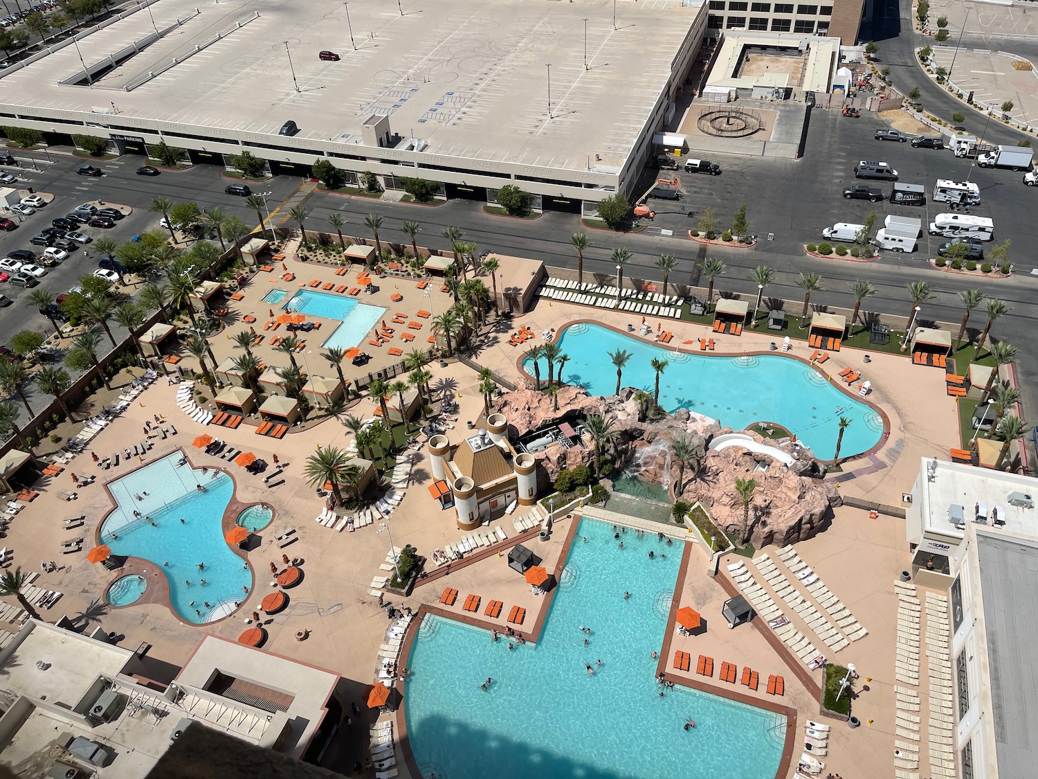 a pool area with a building and parking lot