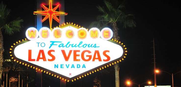 a sign with lights on it with Welcome to Fabulous Las Vegas sign in the background