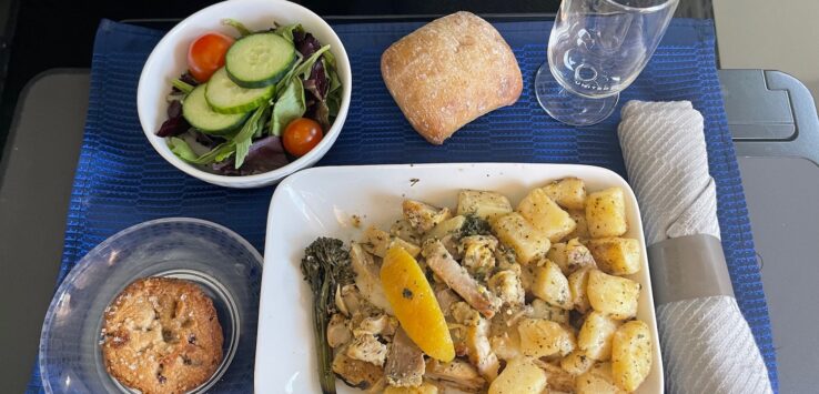 a plate of food and a salad on a table