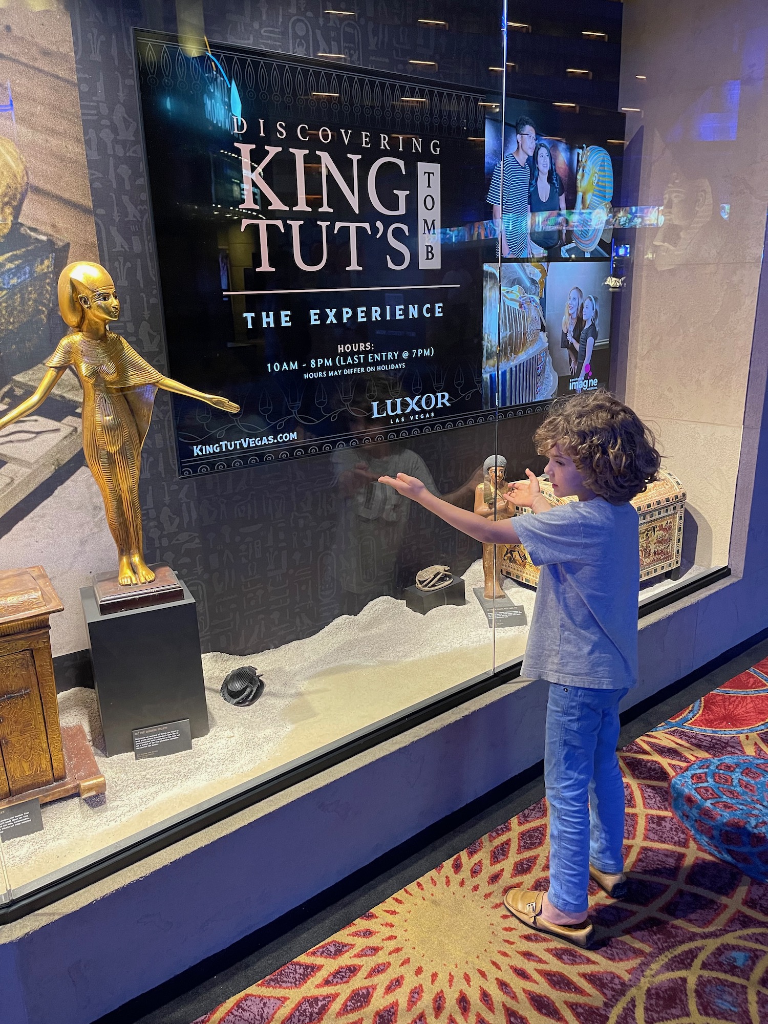 a boy touching a display