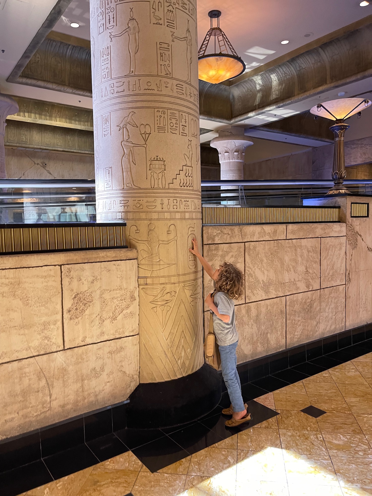 a child touching a pillar