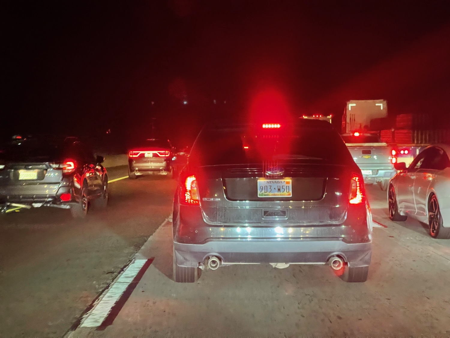 a group of cars on a road at night