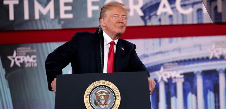 a man standing behind a podium