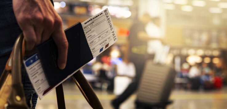 a person holding a passport and boarding pass