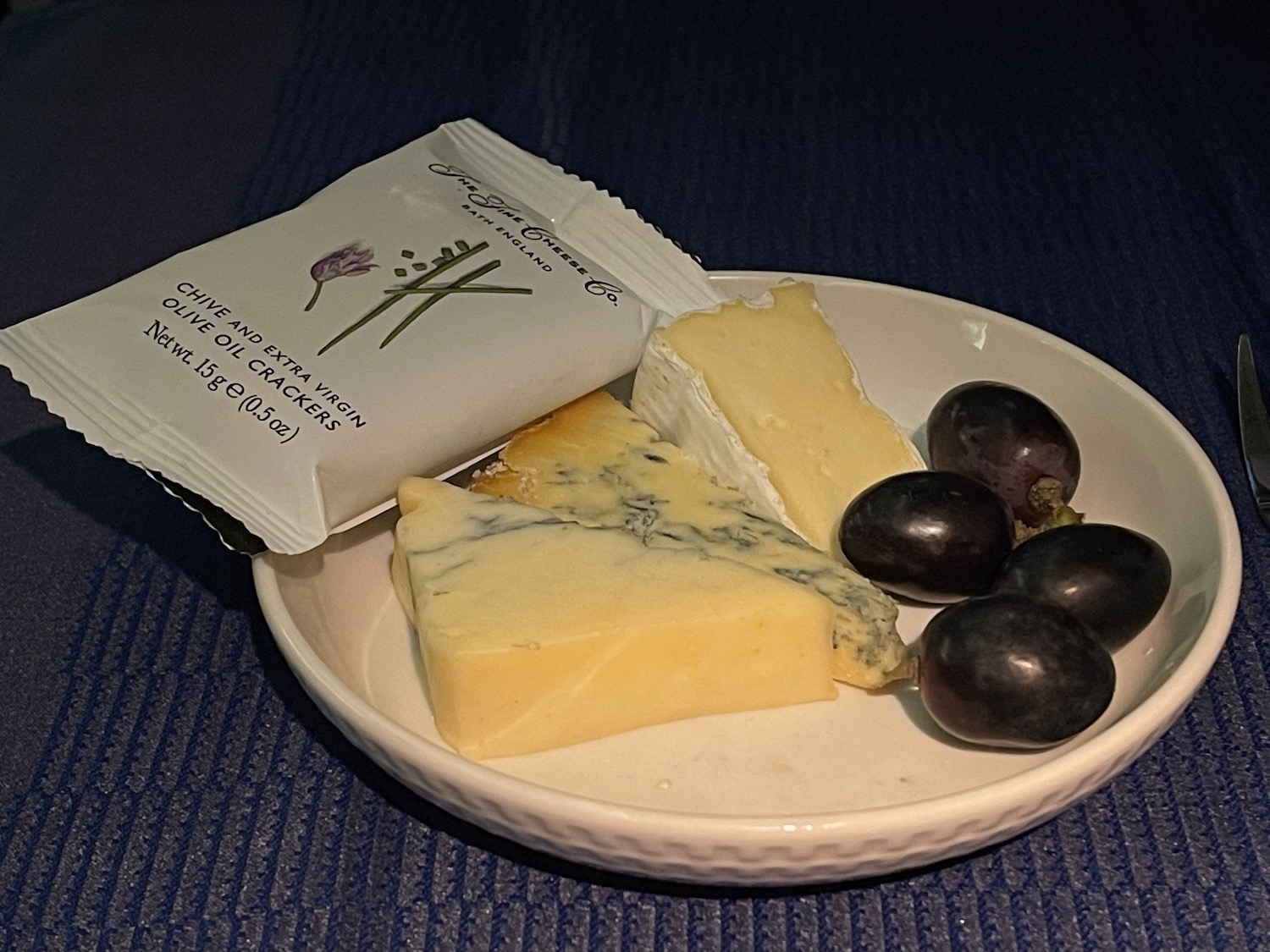 a plate of cheese and grapes