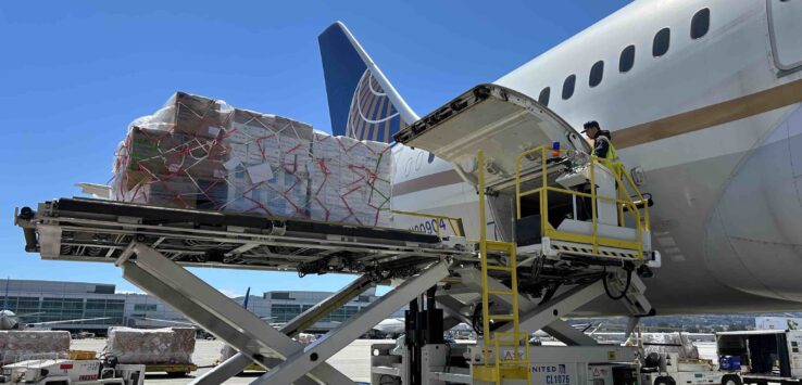 a plane loading cargo into an airplane