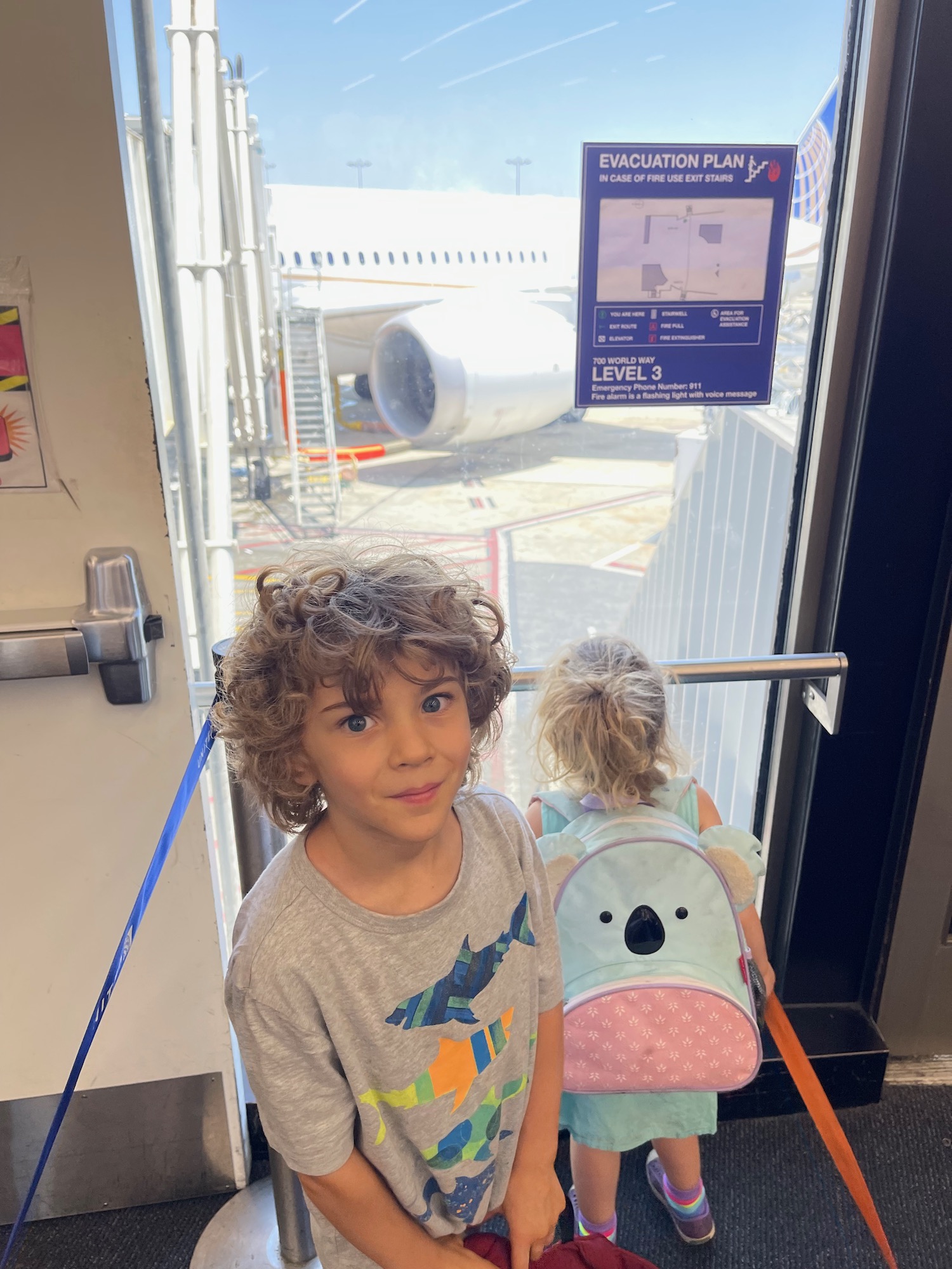 a boy and girl standing in an airport