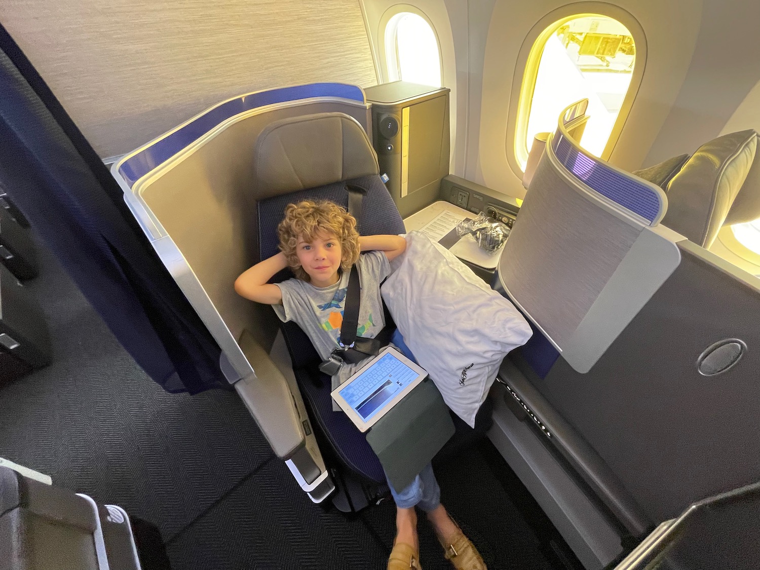 a child sitting in a seat on an airplane