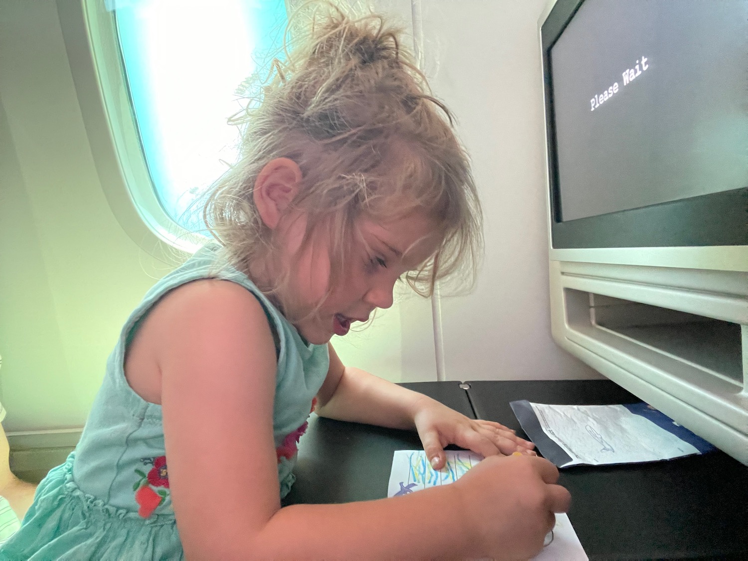 a girl drawing on a piece of paper