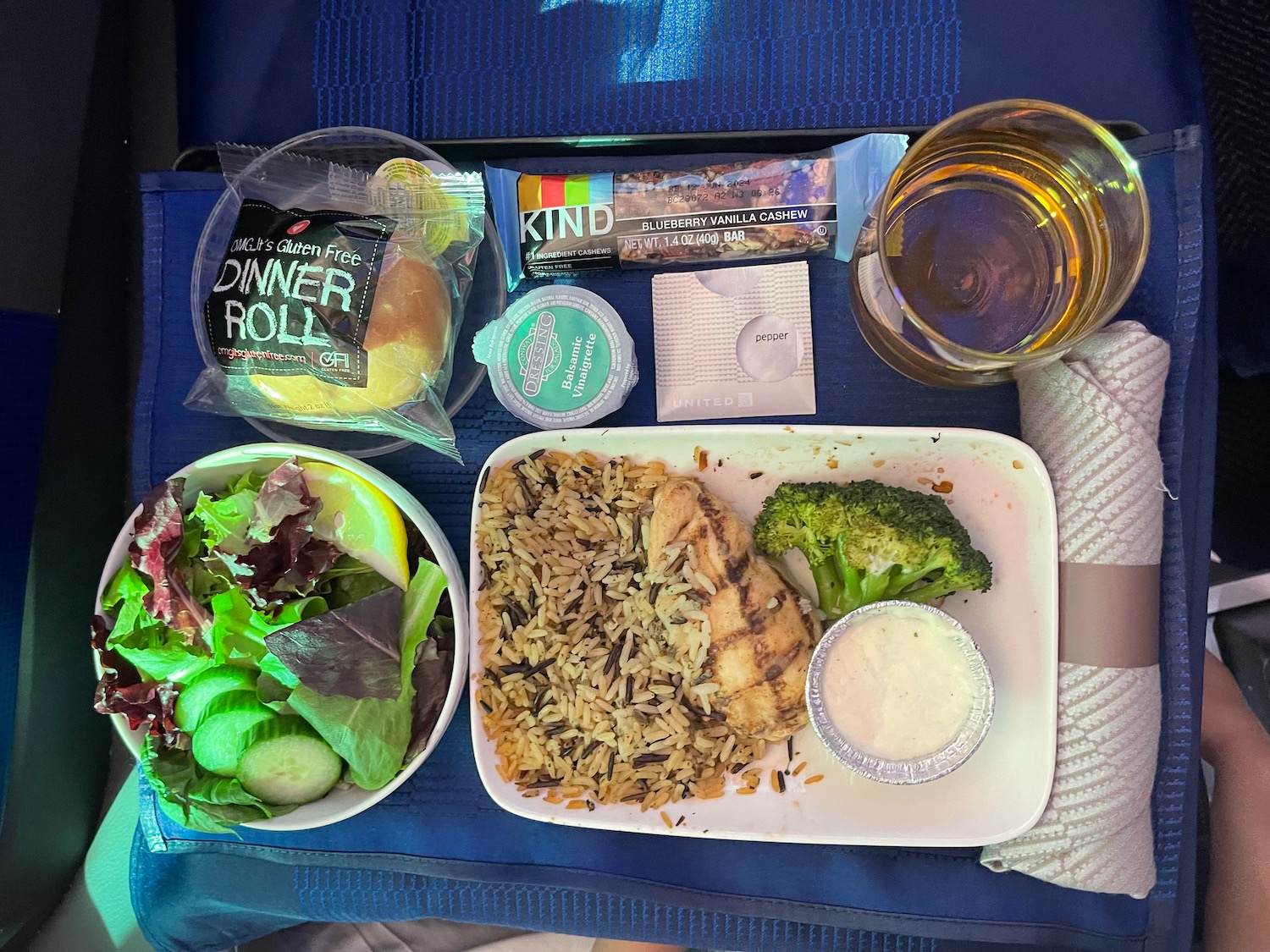 a plate of food and drinks on a blue surface