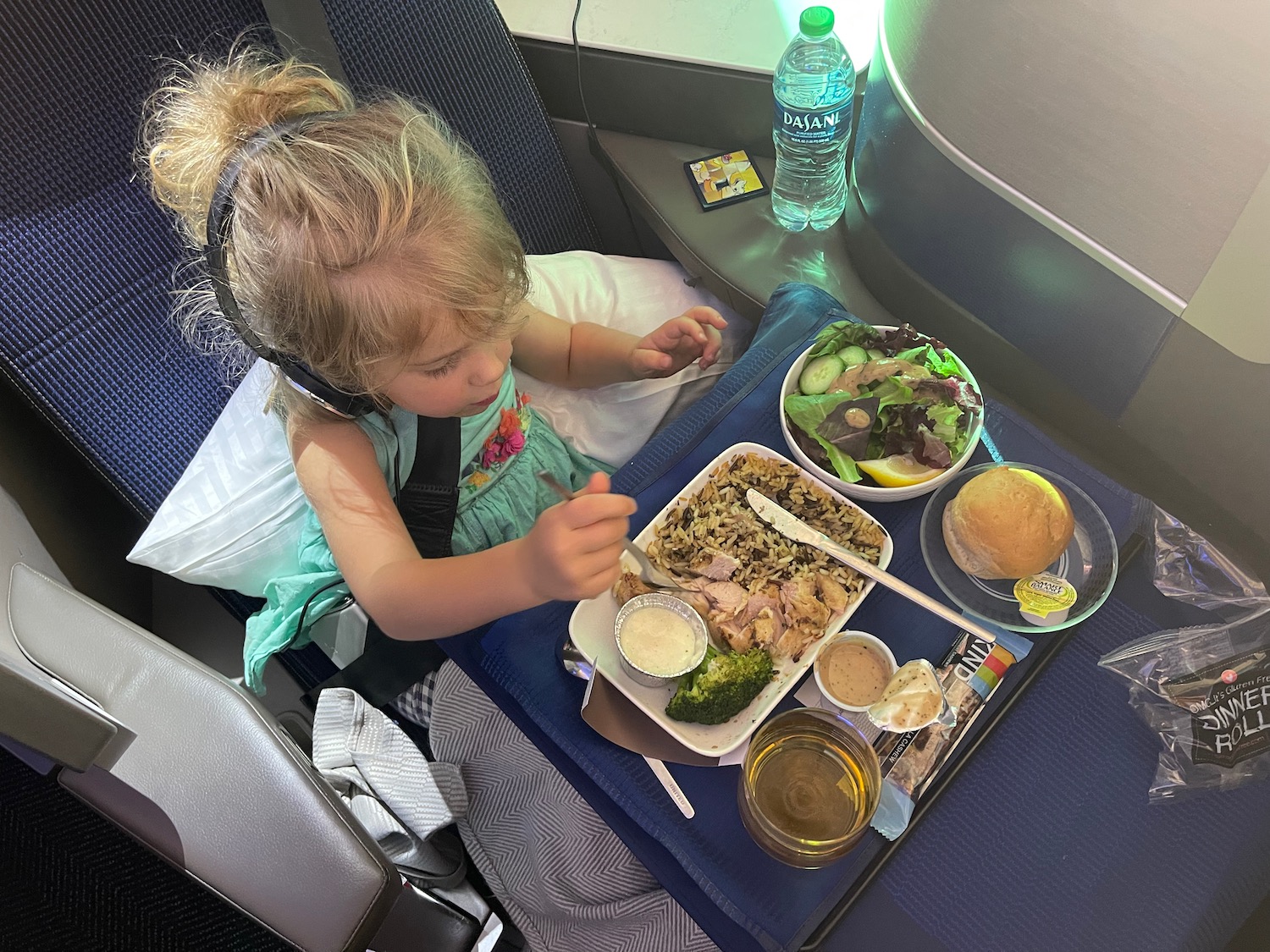 a girl eating food on a plane