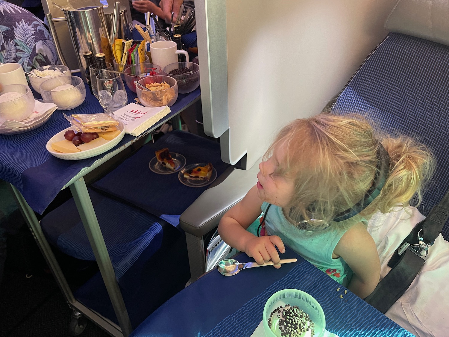 a girl eating food on an airplane