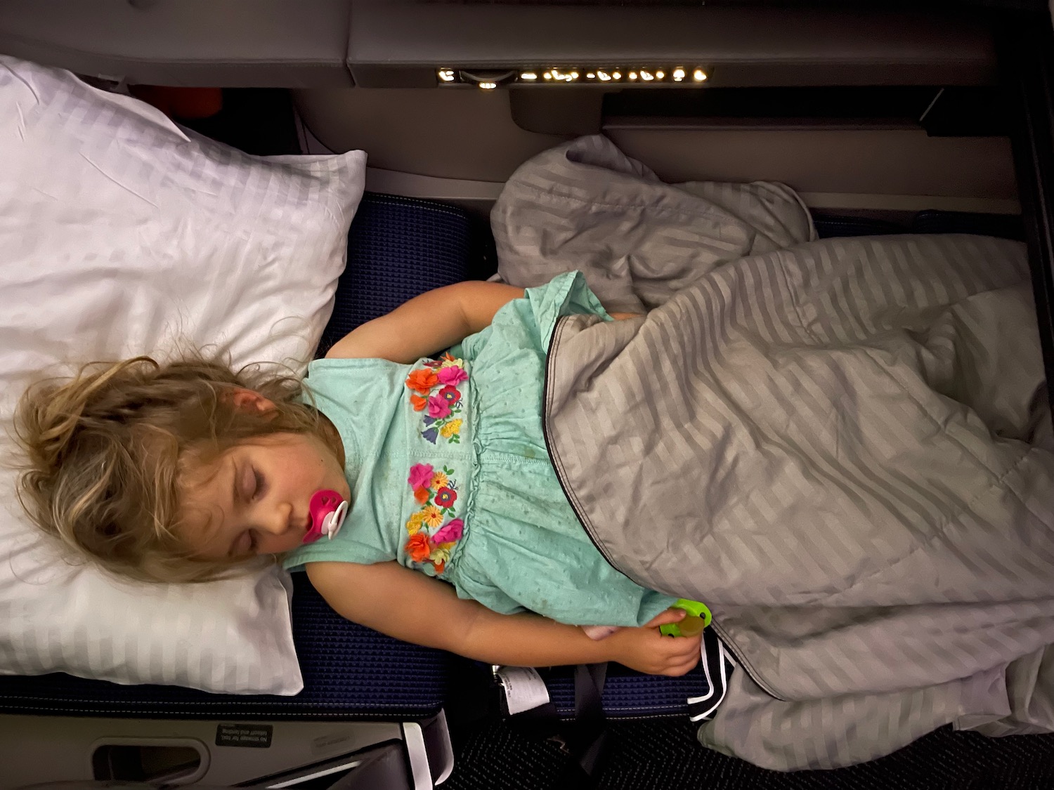 a girl sleeping on a plane