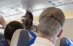 a group of men sitting on an airplane